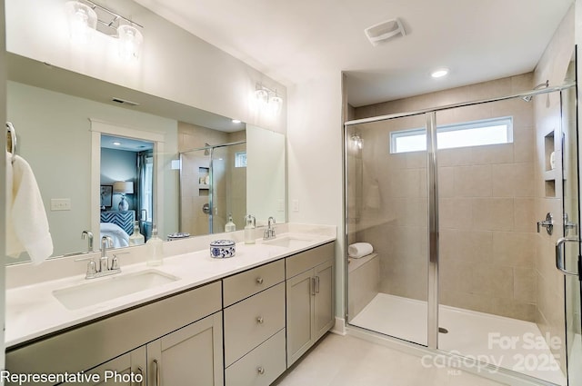 bathroom featuring vanity and a shower with shower door