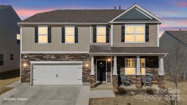 craftsman house featuring a porch, an attached garage, driveway, stone siding, and roof with shingles