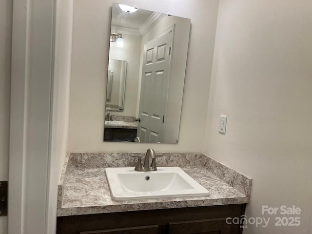 bathroom with vanity and crown molding