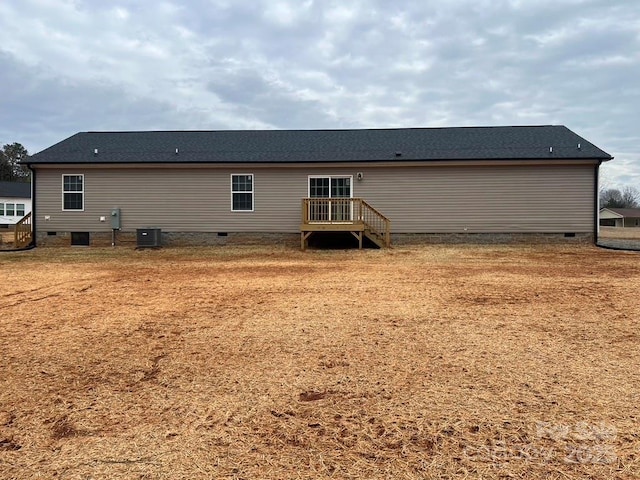 back of property featuring central AC and crawl space