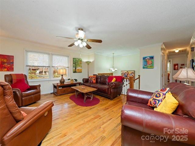 living room featuring ornamental molding, light wood finished floors, and ceiling fan