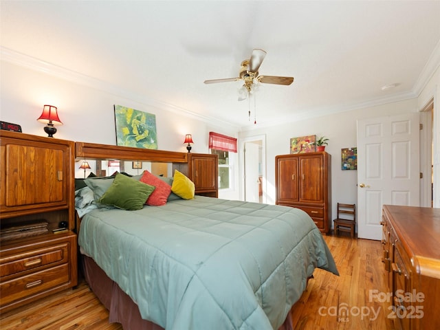 bedroom featuring ornamental molding, light wood-style flooring, and ceiling fan