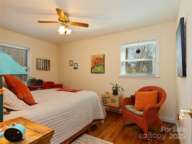 bedroom featuring baseboards, ceiling fan, and wood finished floors