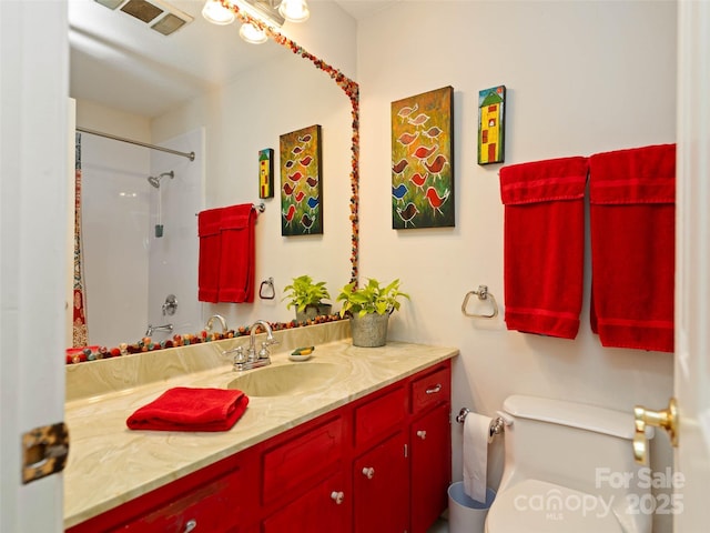 bathroom with toilet, vanity, walk in shower, and visible vents