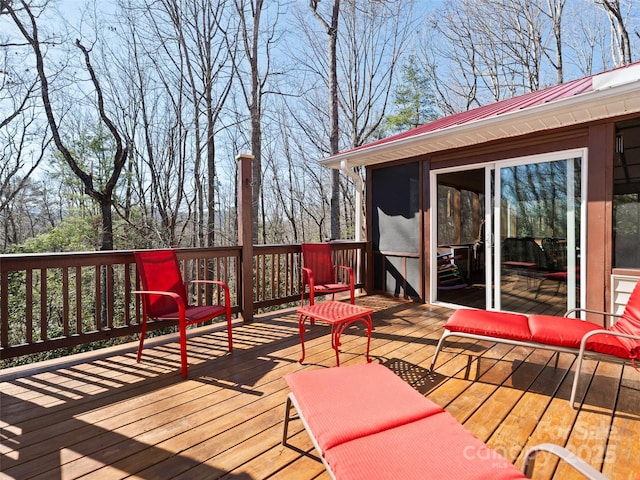 wooden deck with a sunroom