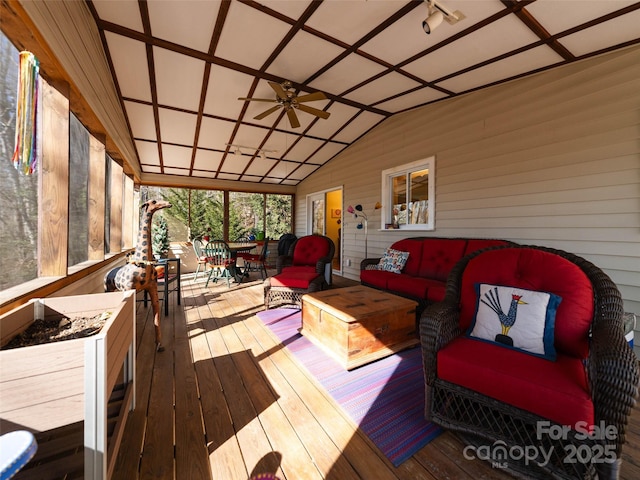 wooden deck with a ceiling fan and outdoor lounge area
