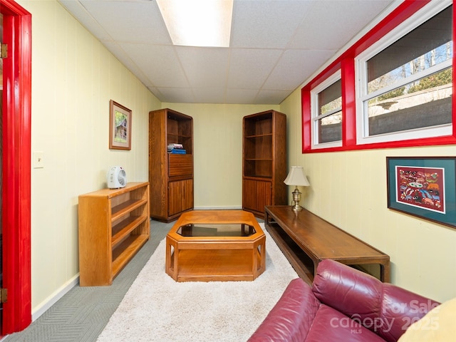 interior space with a drop ceiling and carpet floors