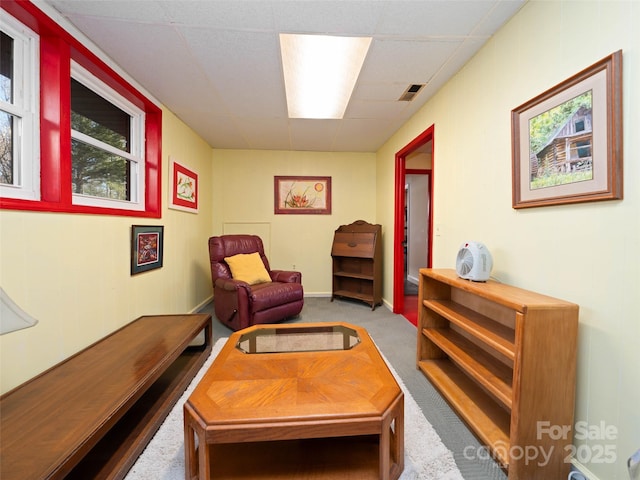 living area featuring carpet floors and visible vents