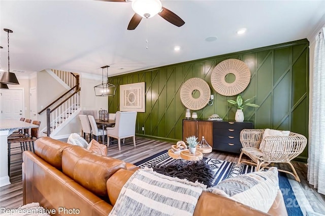 living room with crown molding, ceiling fan, and dark hardwood / wood-style flooring