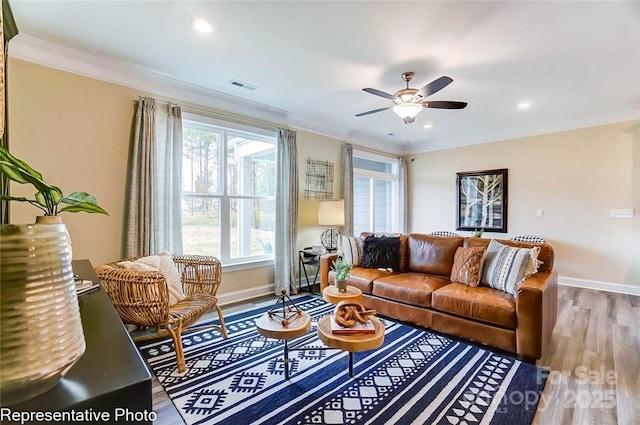 living room with crown molding, hardwood / wood-style floors, and ceiling fan