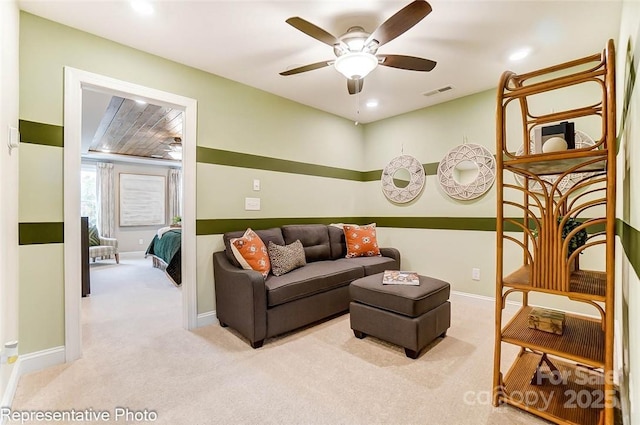 carpeted living room featuring ceiling fan