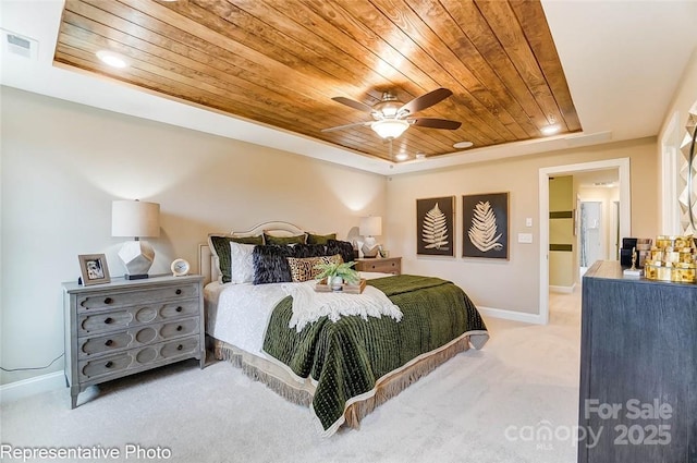 bedroom featuring a raised ceiling, carpet, wooden ceiling, and ceiling fan