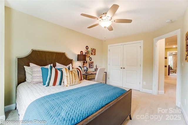 carpeted bedroom featuring a closet and ceiling fan