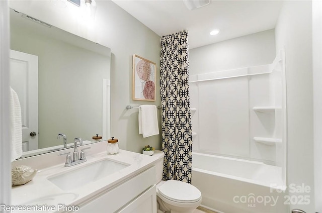 full bathroom featuring vanity, shower / bath combo, and toilet