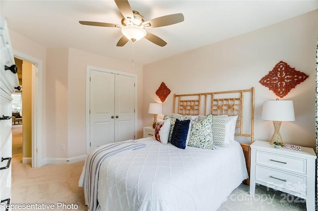 carpeted bedroom with a closet and ceiling fan