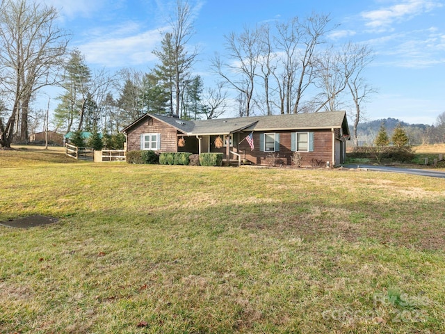 ranch-style home featuring a front yard