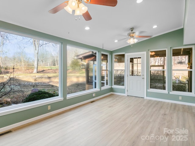 unfurnished sunroom featuring lofted ceiling and ceiling fan