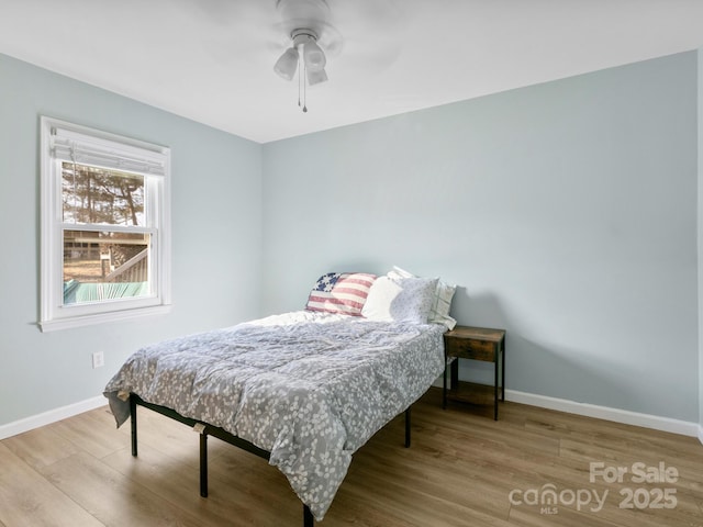 bedroom with wood-type flooring and ceiling fan