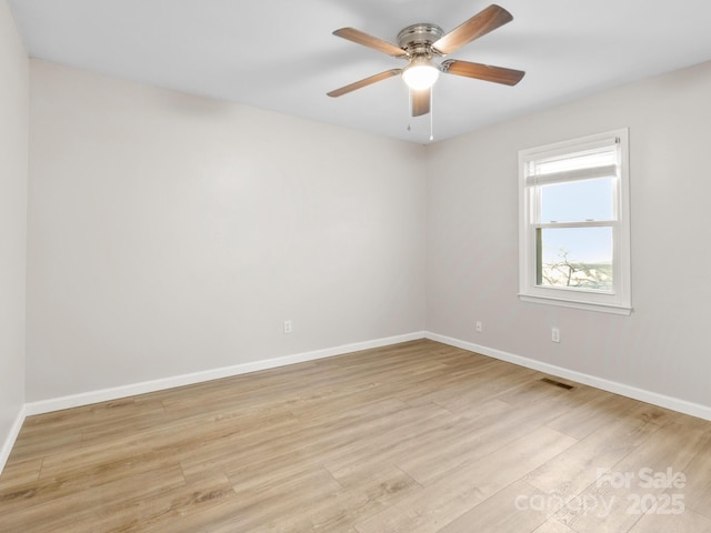 empty room with light hardwood / wood-style floors and ceiling fan