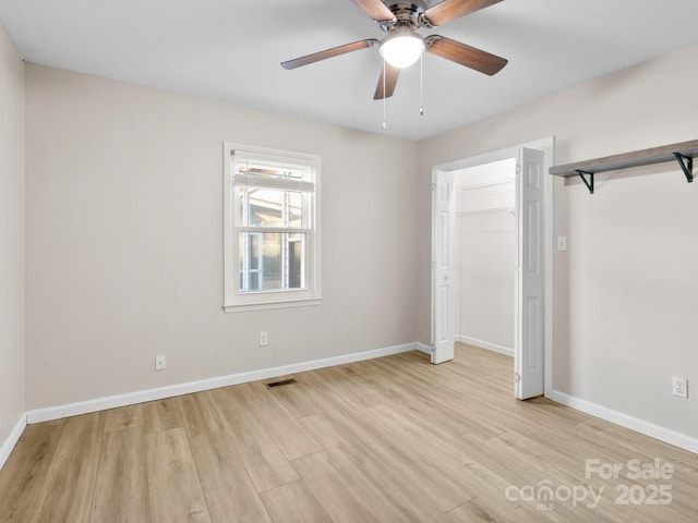 unfurnished bedroom with light hardwood / wood-style floors, a closet, and ceiling fan