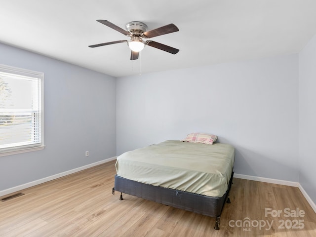 bedroom featuring ceiling fan and light hardwood / wood-style flooring