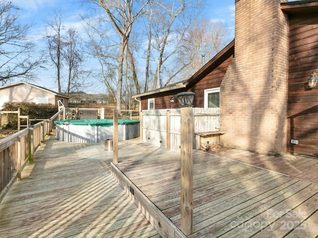 wooden deck with a covered pool