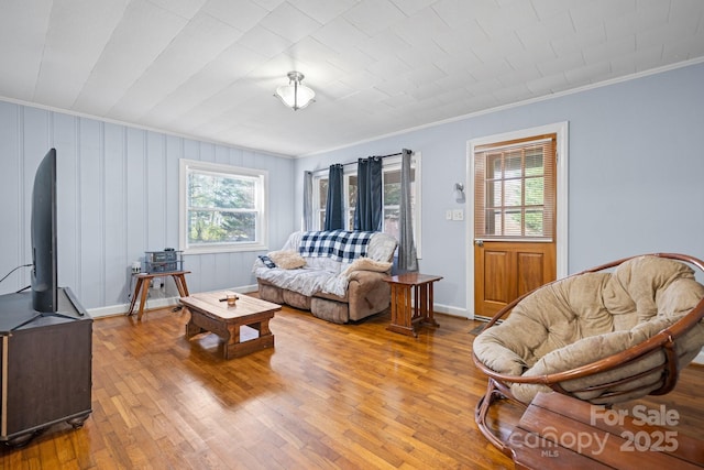 living room featuring crown molding and wood-type flooring