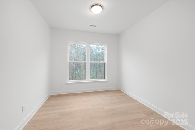 spare room featuring light wood-type flooring