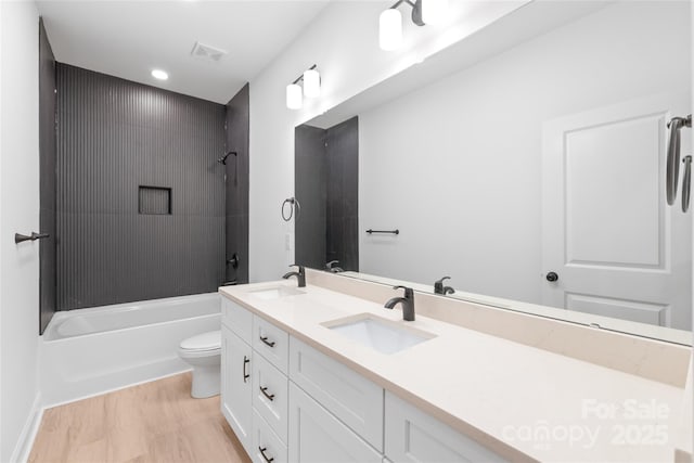 full bathroom with vanity, wood-type flooring, bathtub / shower combination, and toilet