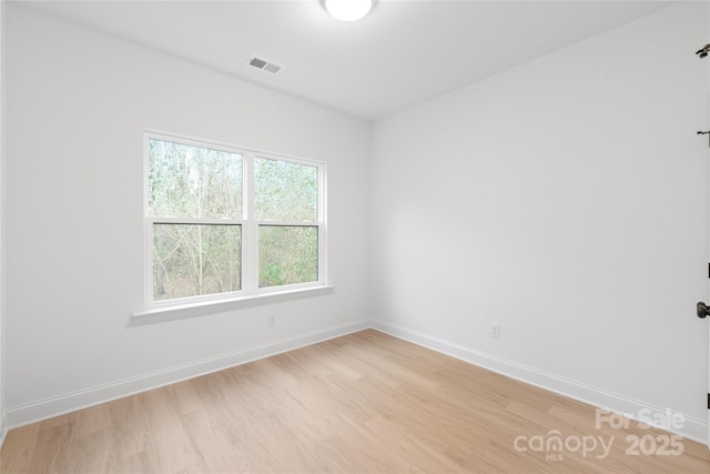 spare room featuring light wood-type flooring