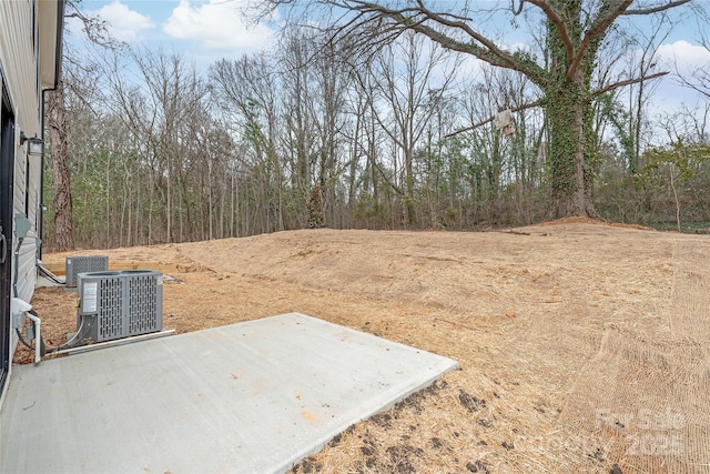 view of yard featuring a patio area and central air condition unit