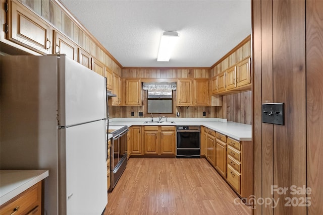 kitchen featuring stainless steel electric stove, black dishwasher, white refrigerator, ornamental molding, and a textured ceiling