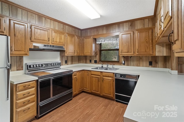 kitchen featuring range with electric cooktop, refrigerator, black dishwasher, sink, and a textured ceiling