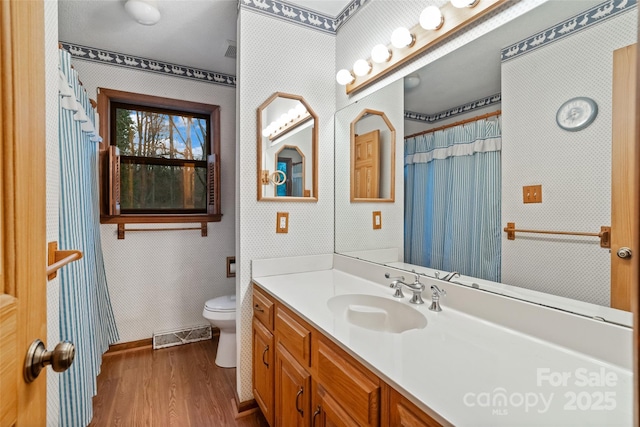 bathroom with vanity, hardwood / wood-style floors, and toilet