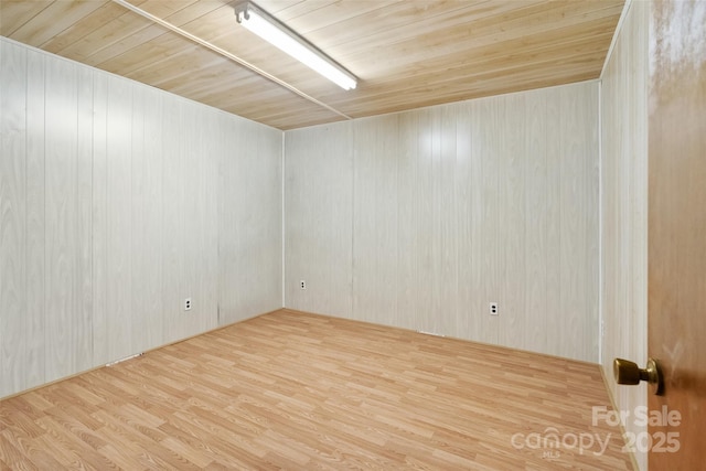 spare room featuring wood-type flooring and wooden ceiling