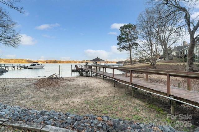 dock area with a gazebo and a water view