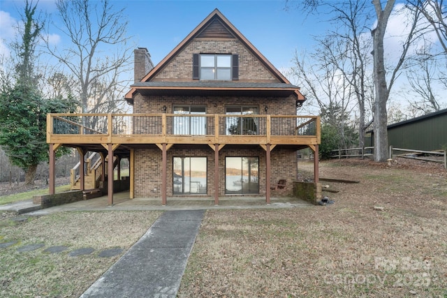 view of front of home with a patio area, a front lawn, and a deck