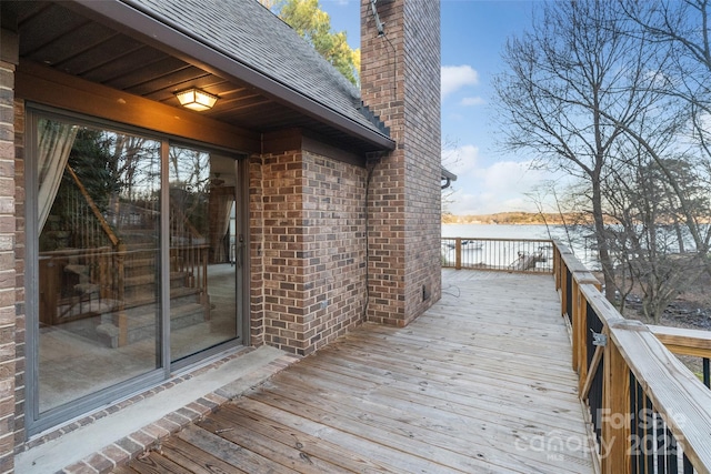 wooden deck featuring a water view