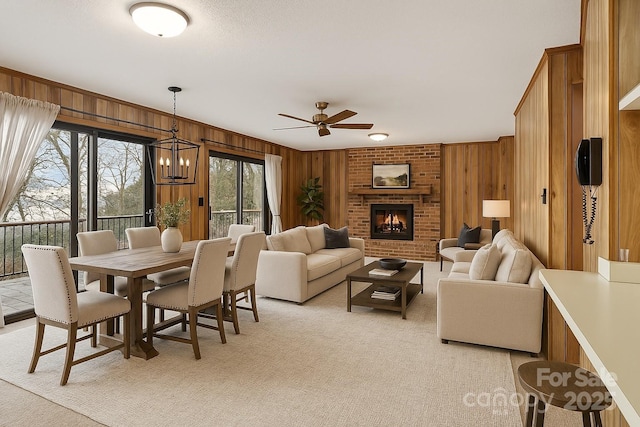 5580 Crepe Myrtle Rd, York, SC 29745 - living room with a ceiling fan, wooden walls, a brick fireplace, light carpet, and a chandelier