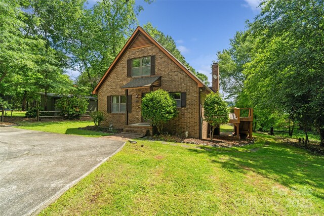5580 Crepe Myrtle Rd, York, SC 29745 - view of front of home featuring a front lawn, a chimney, brick siding, and a wooden deck