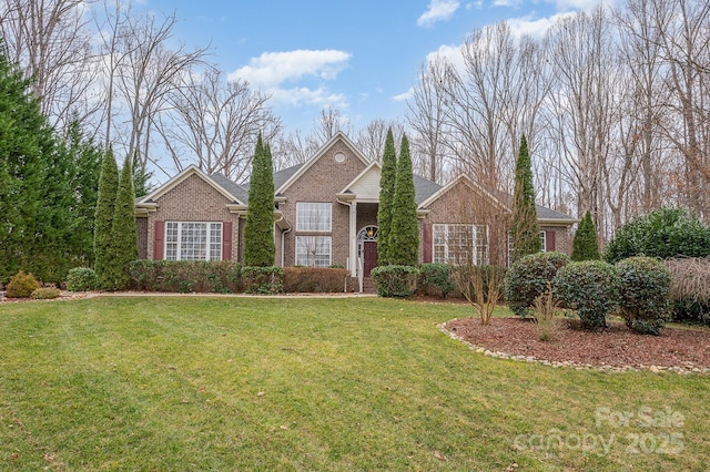 ranch-style home with brick siding and a front lawn