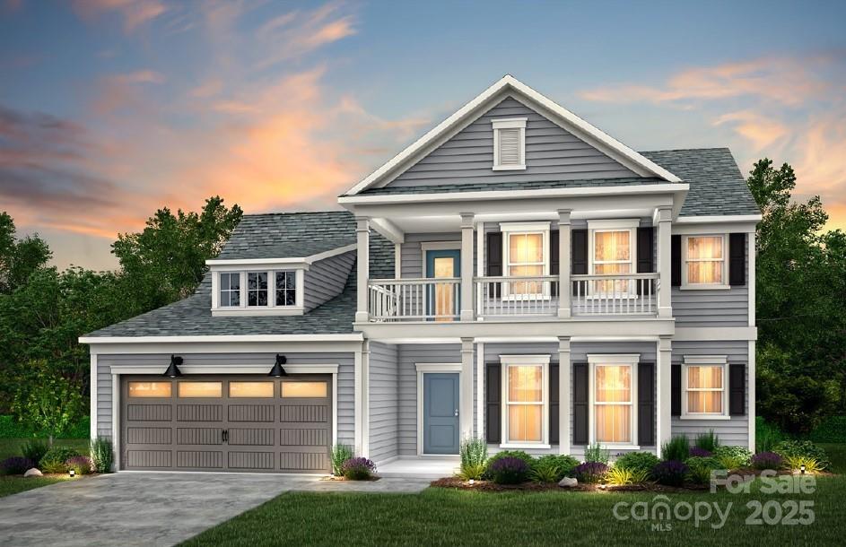 view of front of house with a balcony and a garage