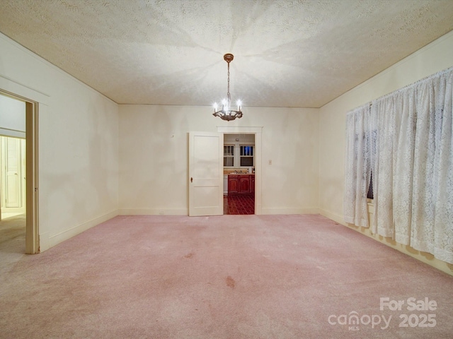 113 2nd St, Spencer, NC 28159 - spare room featuring a chandelier, carpet flooring, baseboards, and a textured ceiling