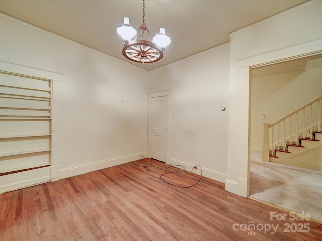 113 2nd St, Spencer, NC 28159 - unfurnished dining area with a chandelier, stairs, wood finished floors, and baseboards