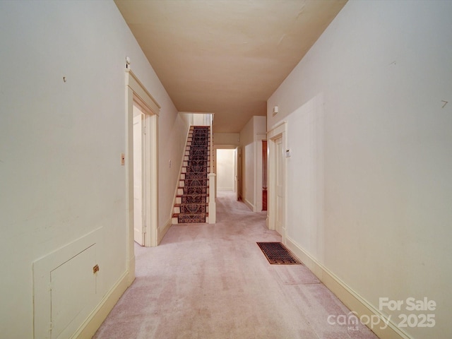 113 2nd St, Spencer, NC 28159 - hall featuring stairway, light carpet, and baseboards