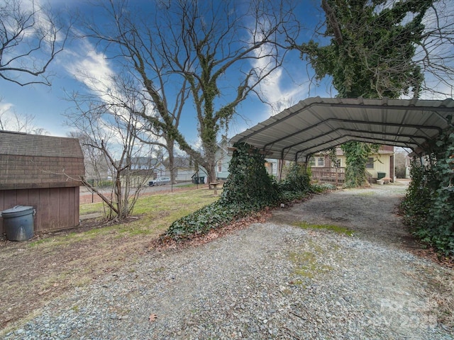 113 2nd St, Spencer, NC 28159 - view of car parking with a detached carport, gravel driveway, and a shed