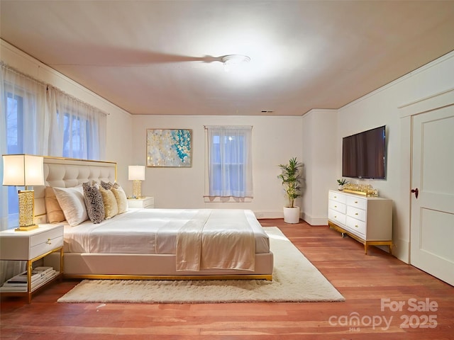 113 2nd St, Spencer, NC 28159 - bedroom with multiple windows and wood finished floors