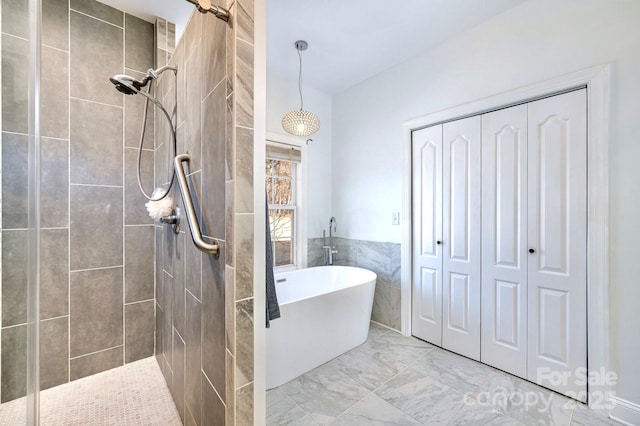 bathroom featuring separate shower and tub and tile walls