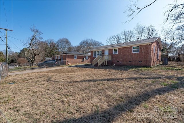 back of property featuring central AC and a lawn