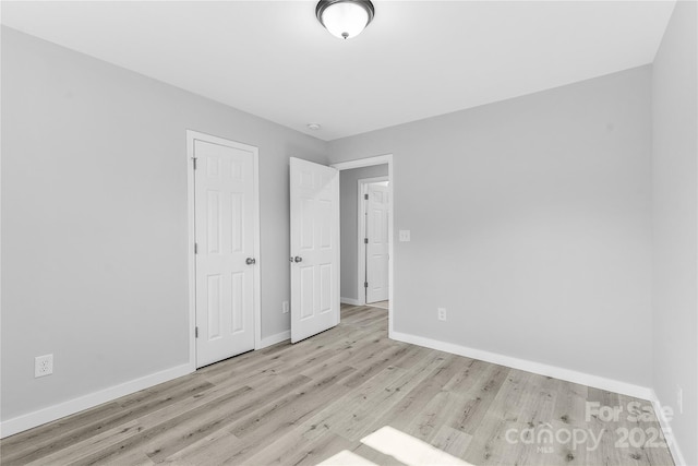 unfurnished bedroom featuring light wood-type flooring